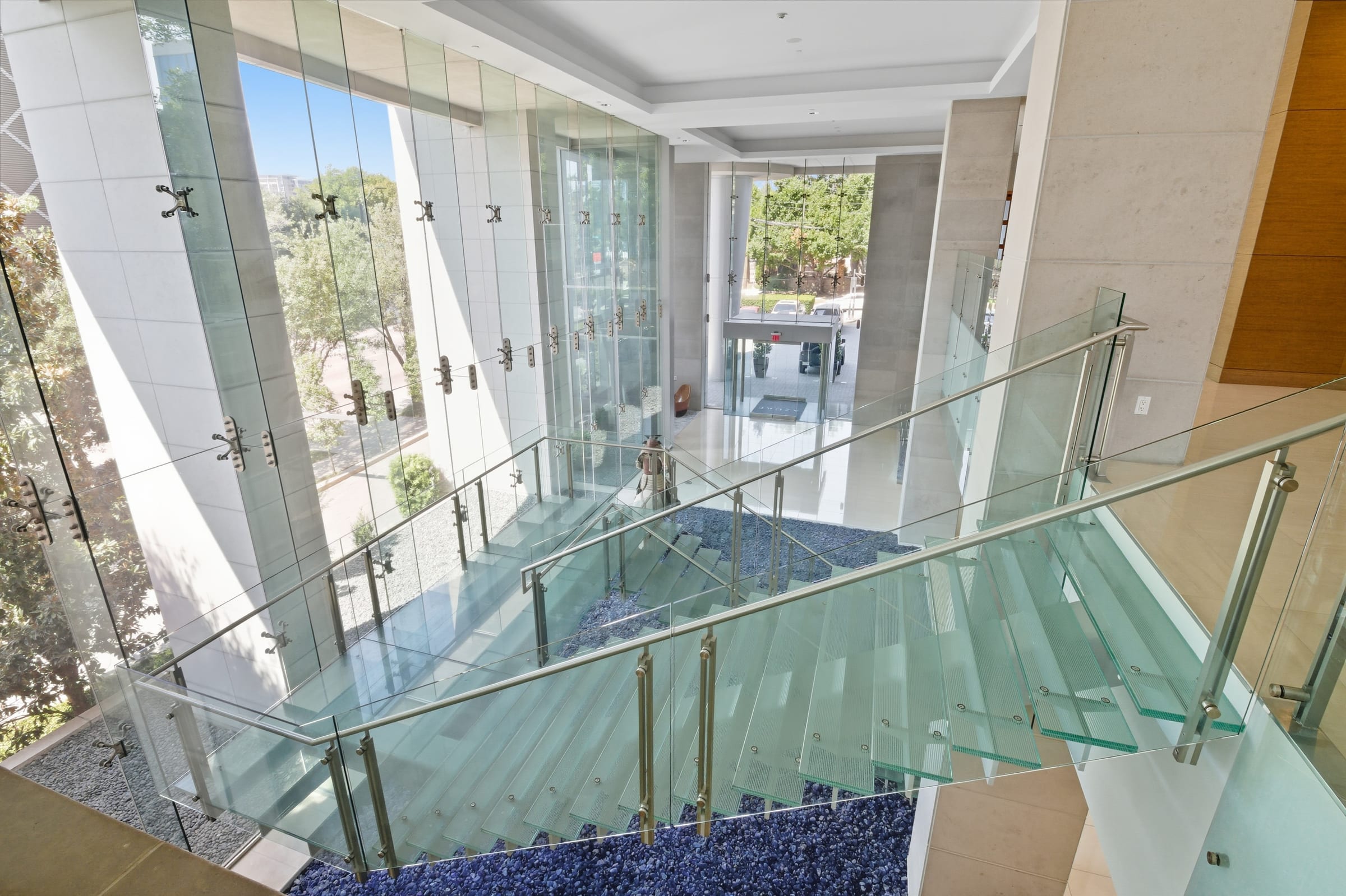 Architectural glass staircase inside a commercial building lobby